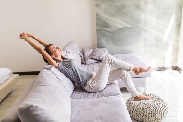 WOMAN SITTING ON A SOFA