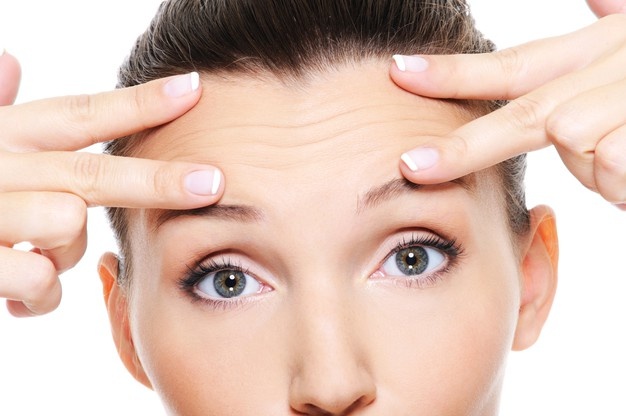 WOMAN TOUCHING HER FACE
